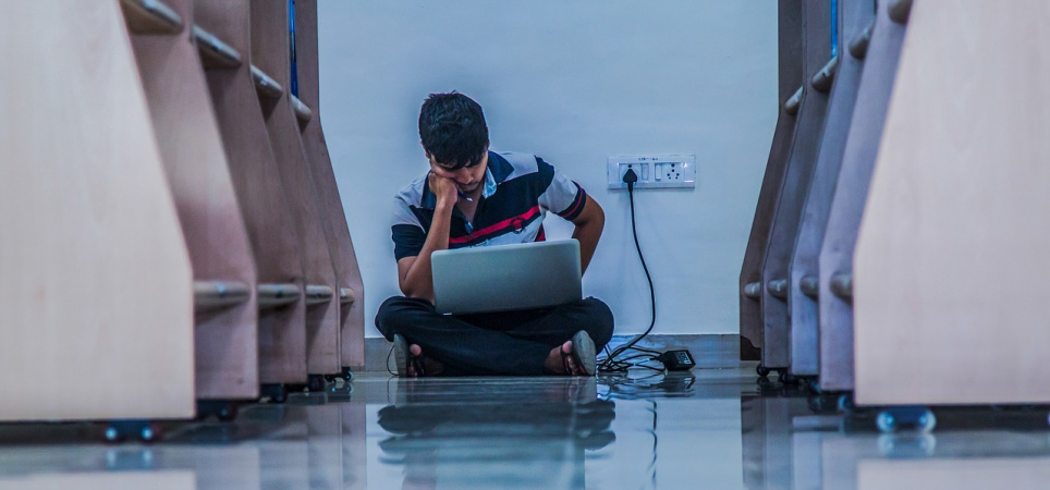 student is working on laptop