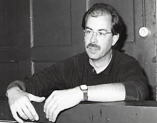 Zwart-wit foto van docent Ton van Rijn toen hij in de aula zat in 1980 - beeld bij de rubriek flashback op aob.nl/onderwijsblad